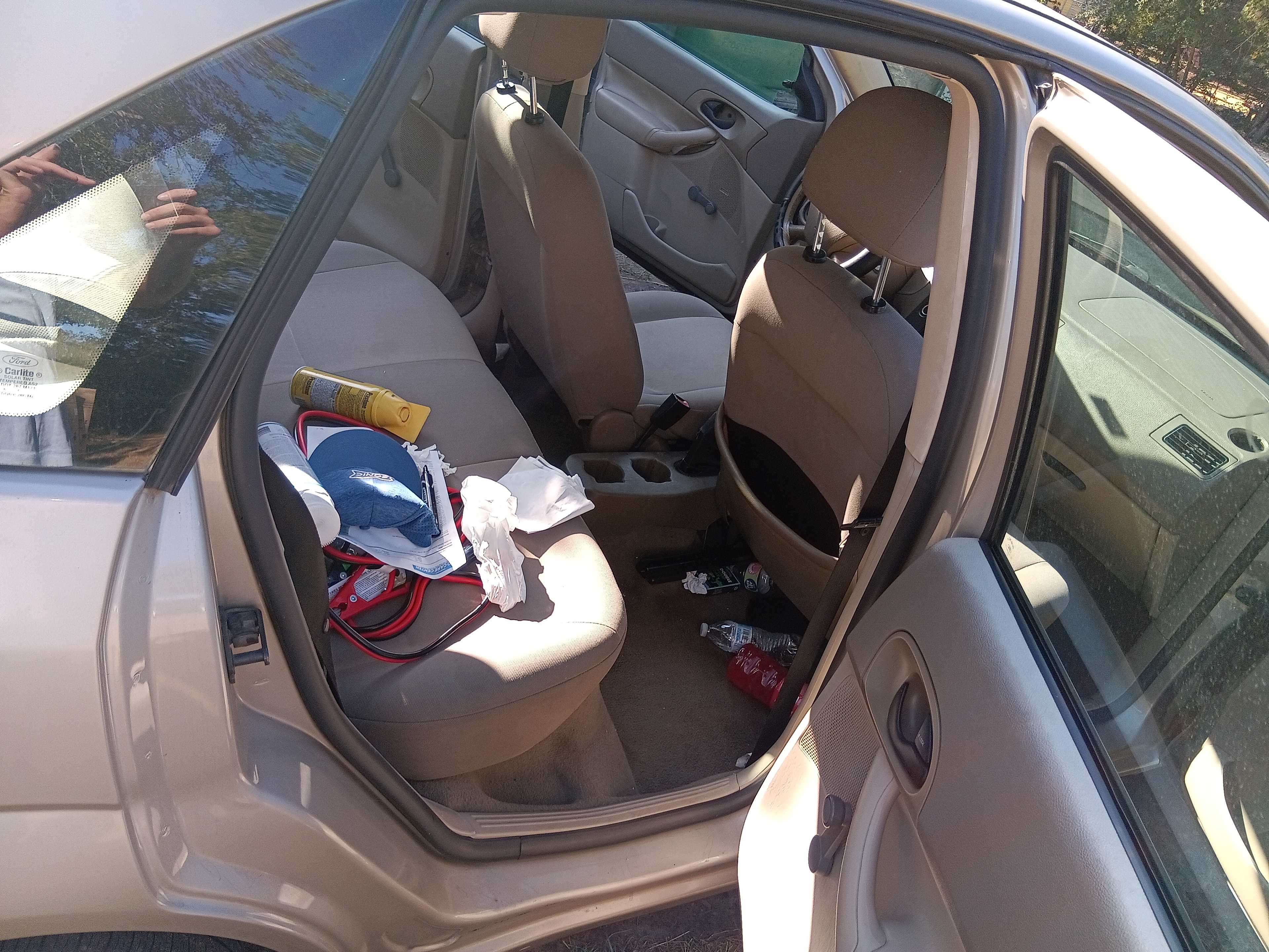 Tan Ford Focus interior before mobile detailing, open-door overview