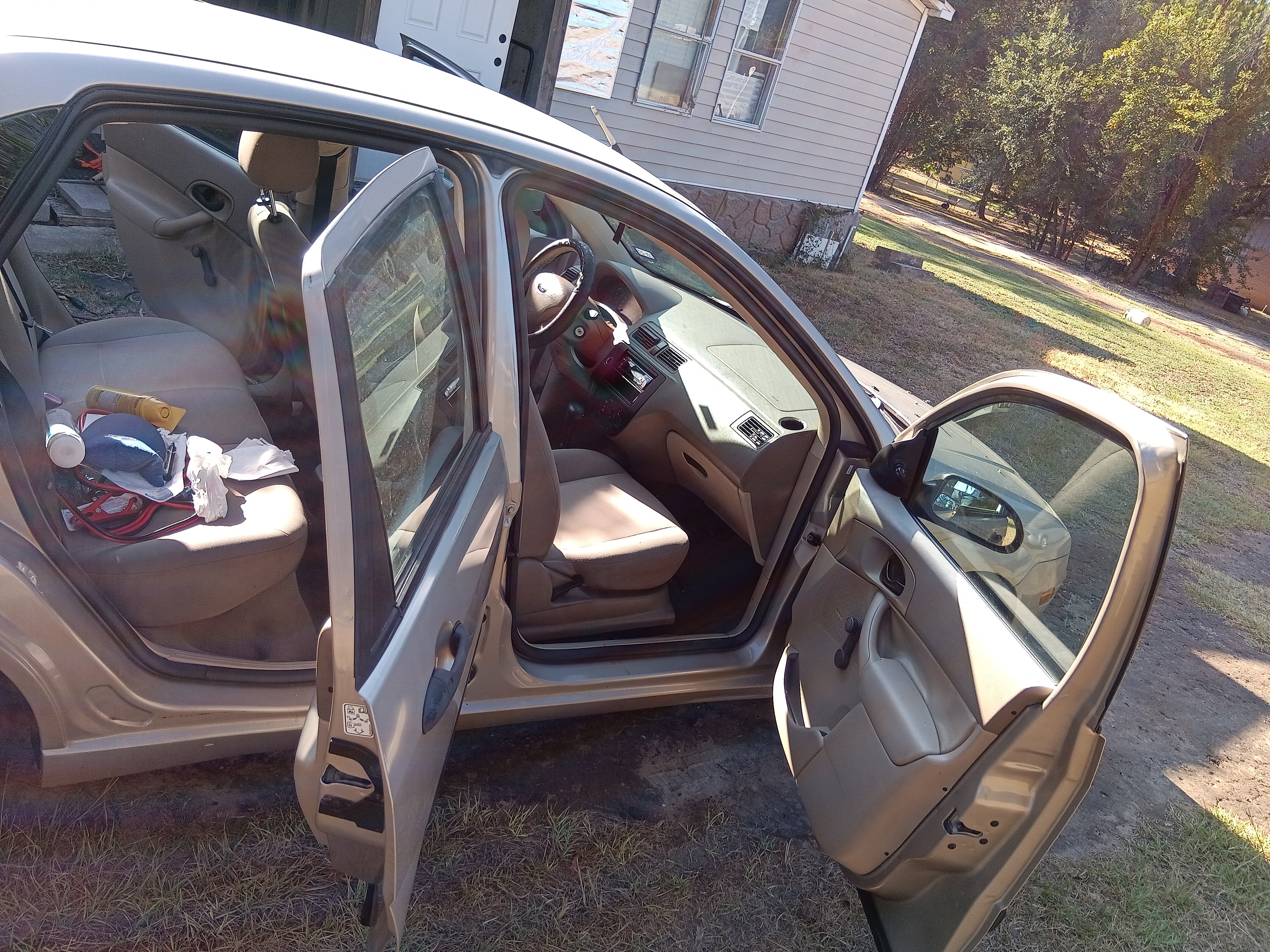 Tan Ford Focus rear-seat area before interior detailing